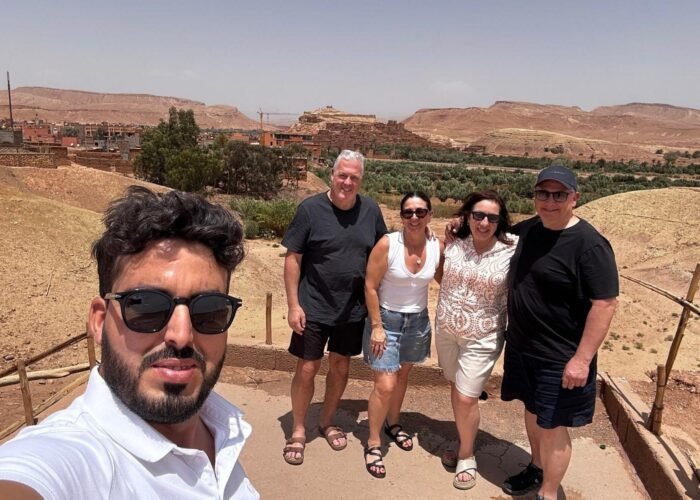 3 Days Desert Tour from Marrakech group photo with Ait Ben Haddou kasbah in the background