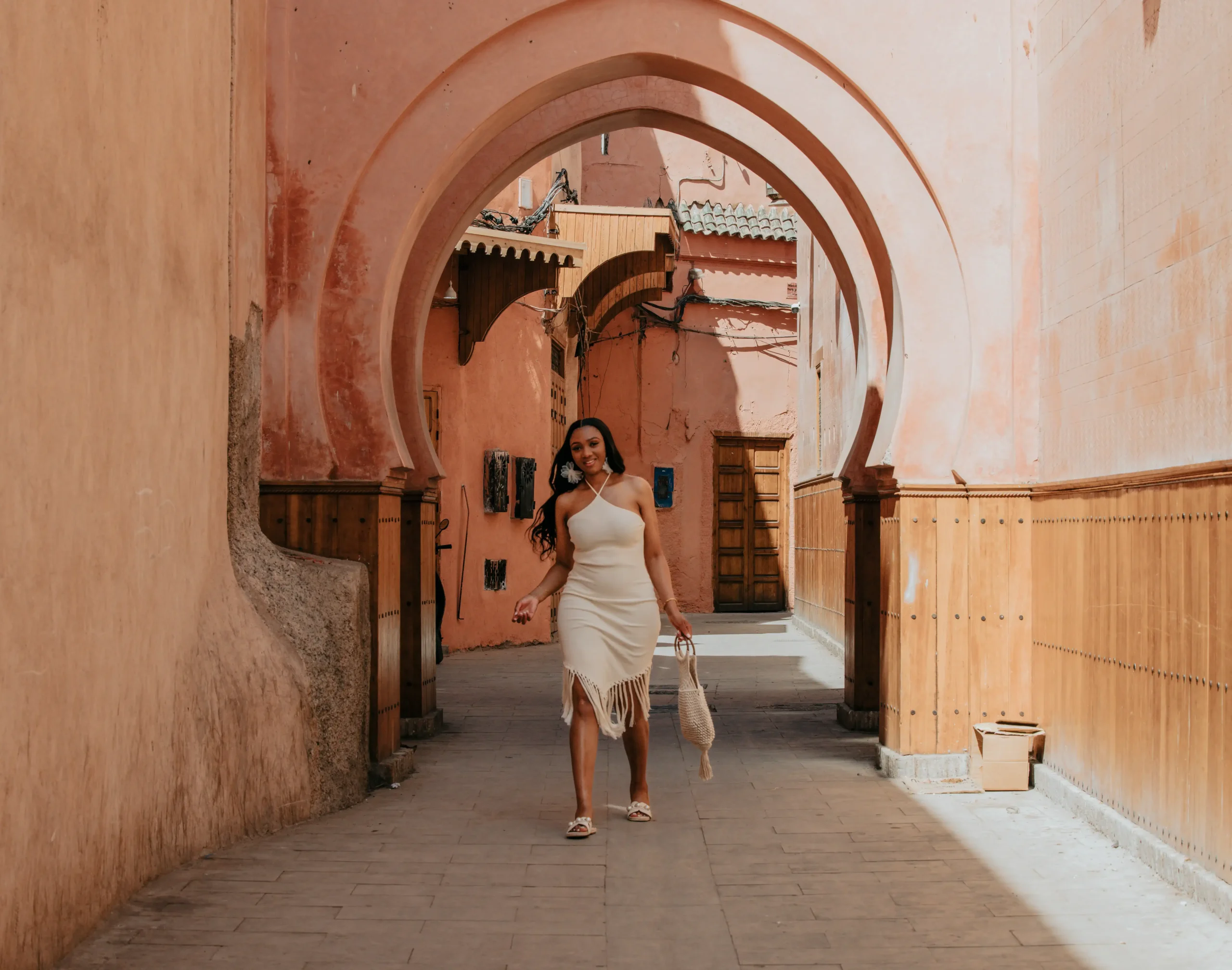 Is Morocco safe for solo female travelers? Woman walking alone through Marrakech's medina archway