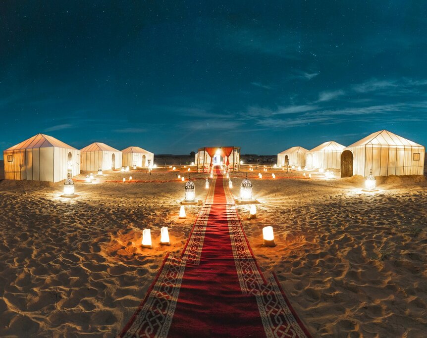 Luxury desert camp lit at night, a popular spot to celebrate New Year in Morocco