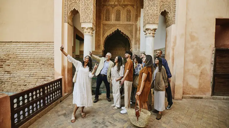 What to wear in Morocco: tourists in modest, breathable outfits at a Marrakech medina