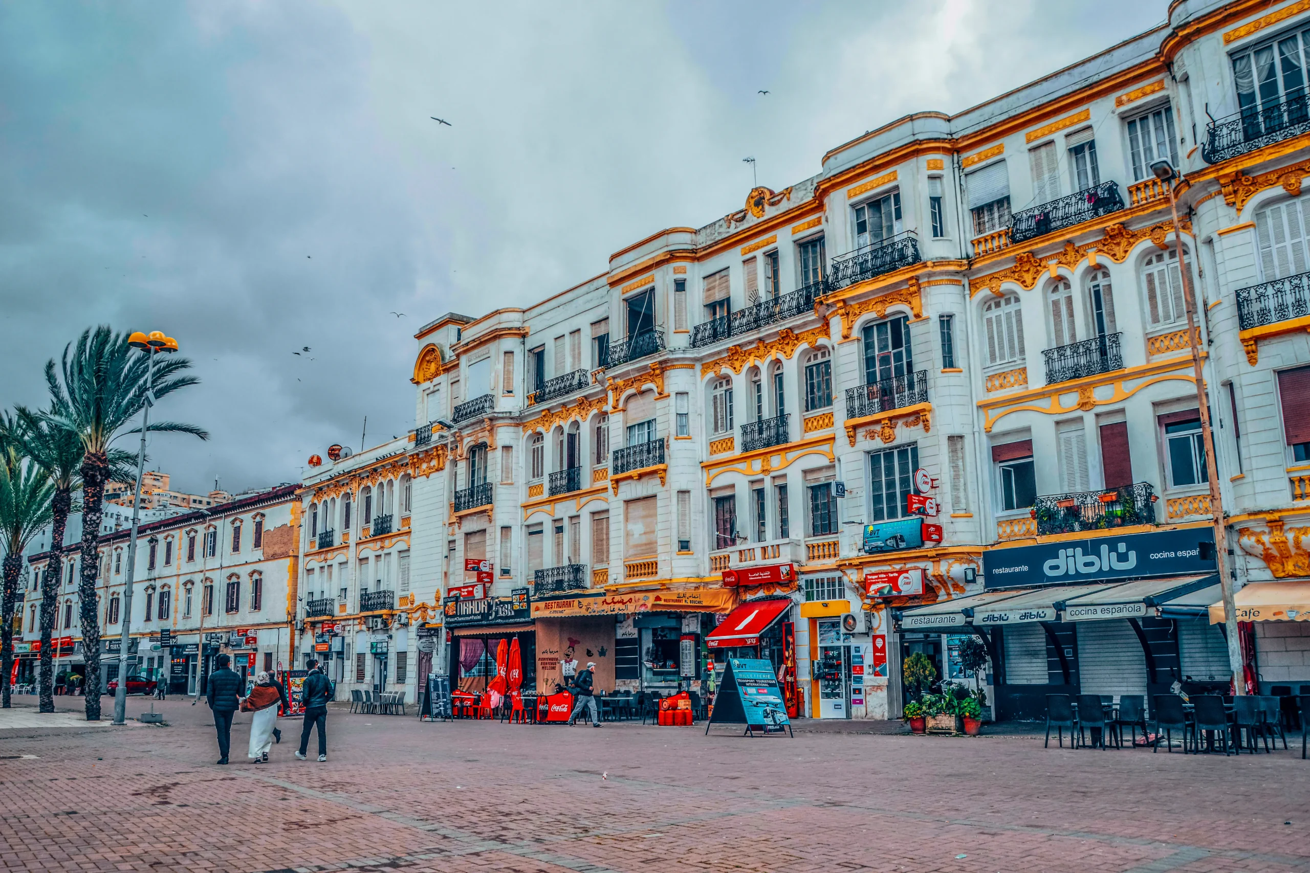 Things to do in Tangier Morocco – historic Spanish-style square with restaurants and palm trees