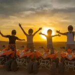 Day Trip from Marrakech to Agafay Desert featuring a camel ride, quad biking adventure, and stunning views of the rocky desert with the Atlas Mountains in Morocco.